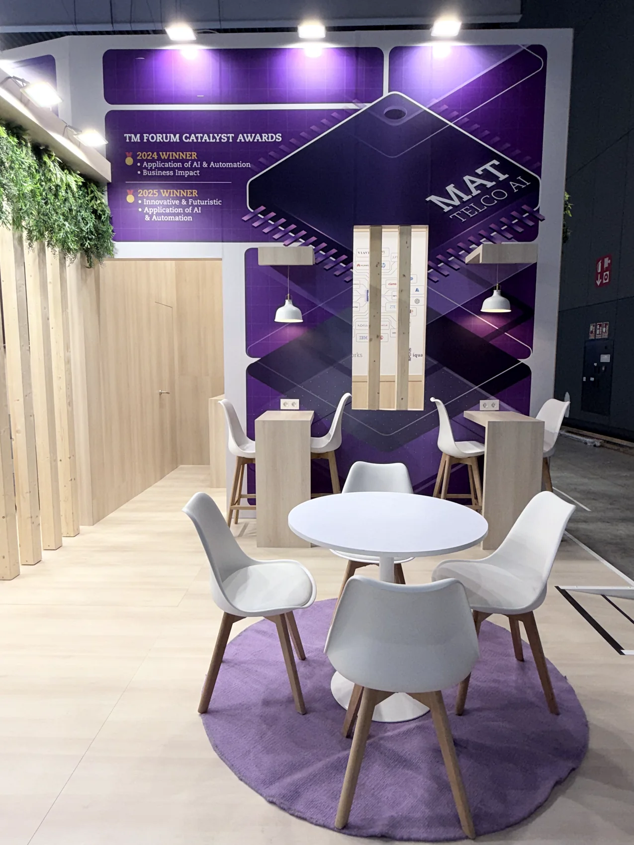 Zona de reuniones con vegetación en un stand diseñado por ROCMA